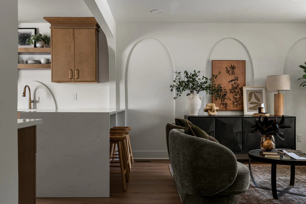 Kitchen and living room with arched wall details and black sideboard