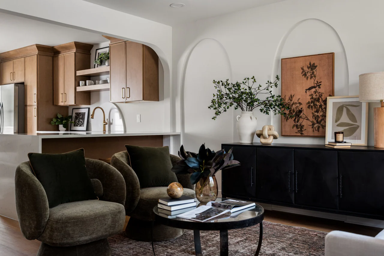 Living room with swivel chairs, sideboard and open kitchen