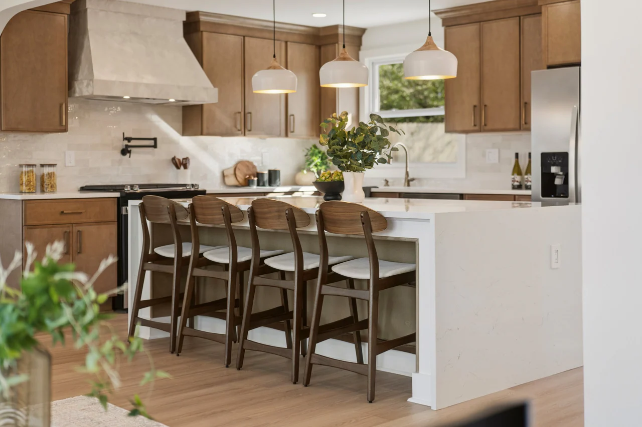 Kitchen island with four wood stools and pendant lights