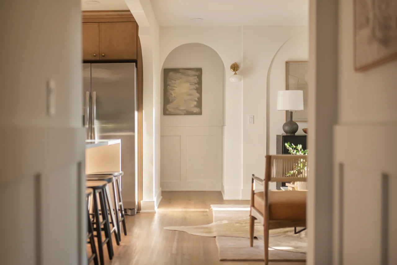 Arched niche with painting, framed by the kitchen island and living room