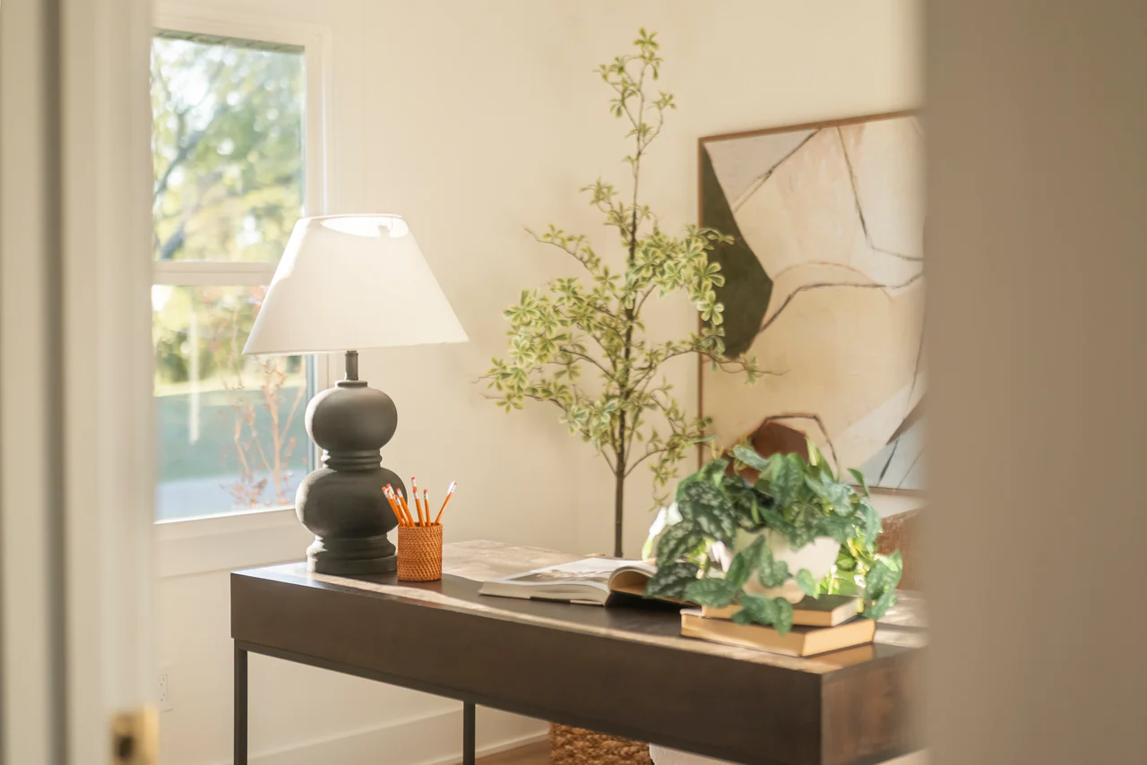Desk with lamp, plants and abstract art