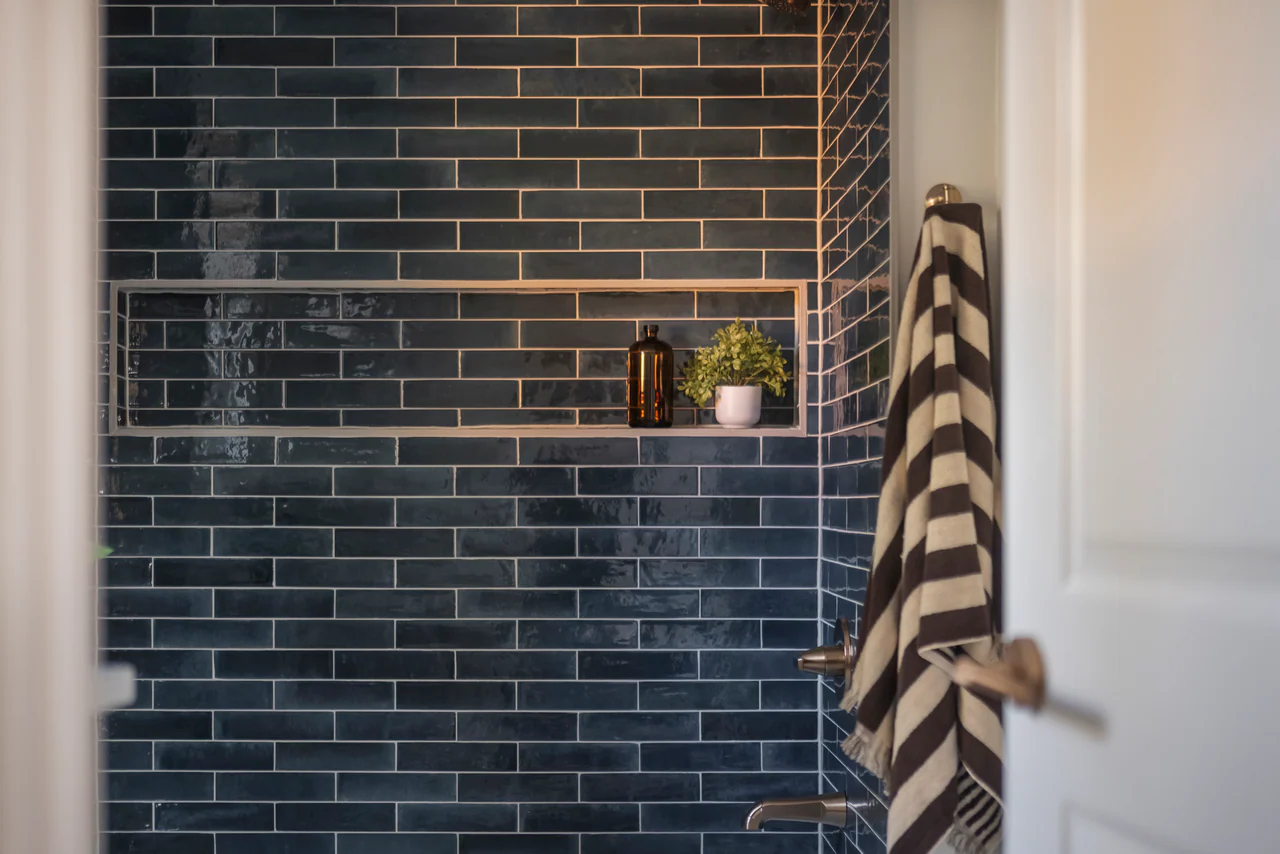 Blue tile shower with recessed niche